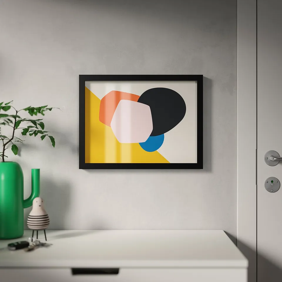 Abstract art in frame, green plant, partially open door.