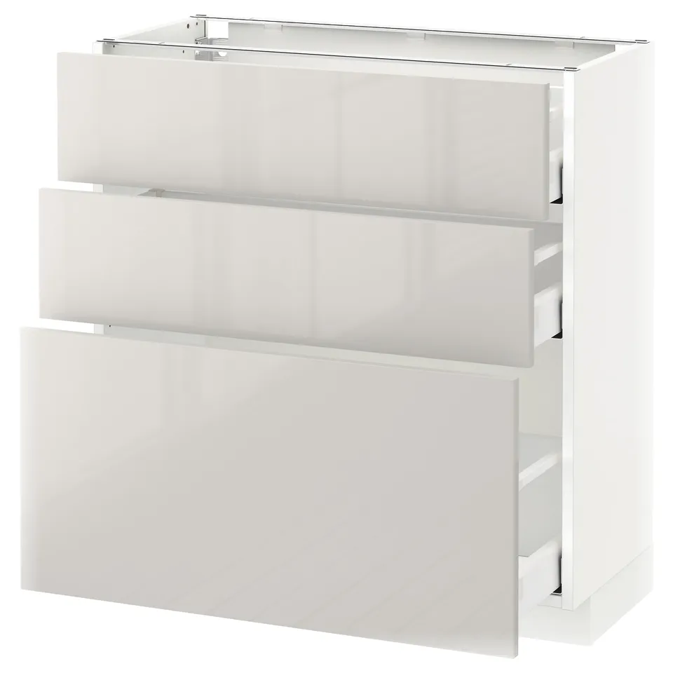 Modern, white, high-gloss, three-drawer cabinet with sleek design from METOD kitchen system.
