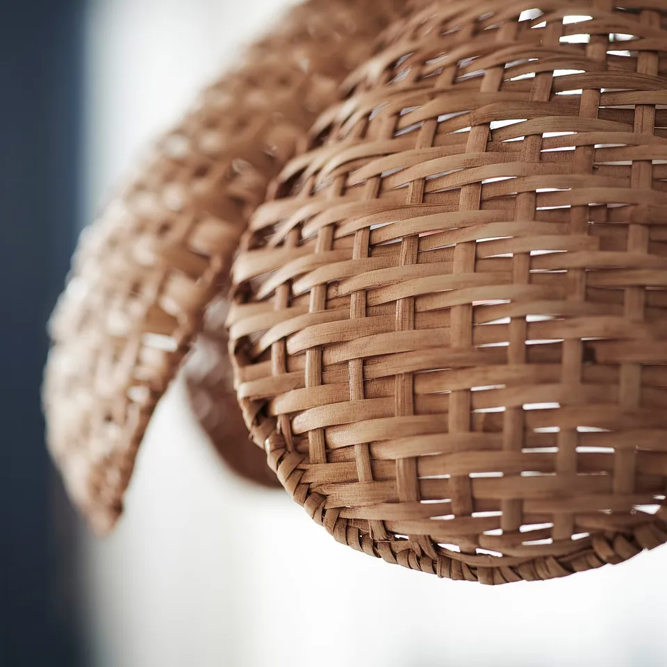 Wicker pendant lampshade with intricate weaving, natural texture, and earthy tone, highlighting its craftsmanship and rustic elegance.