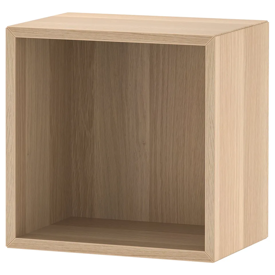 An ikea EKET cube shelf, light brown, square-shaped, with a wooden finish, standing alone.