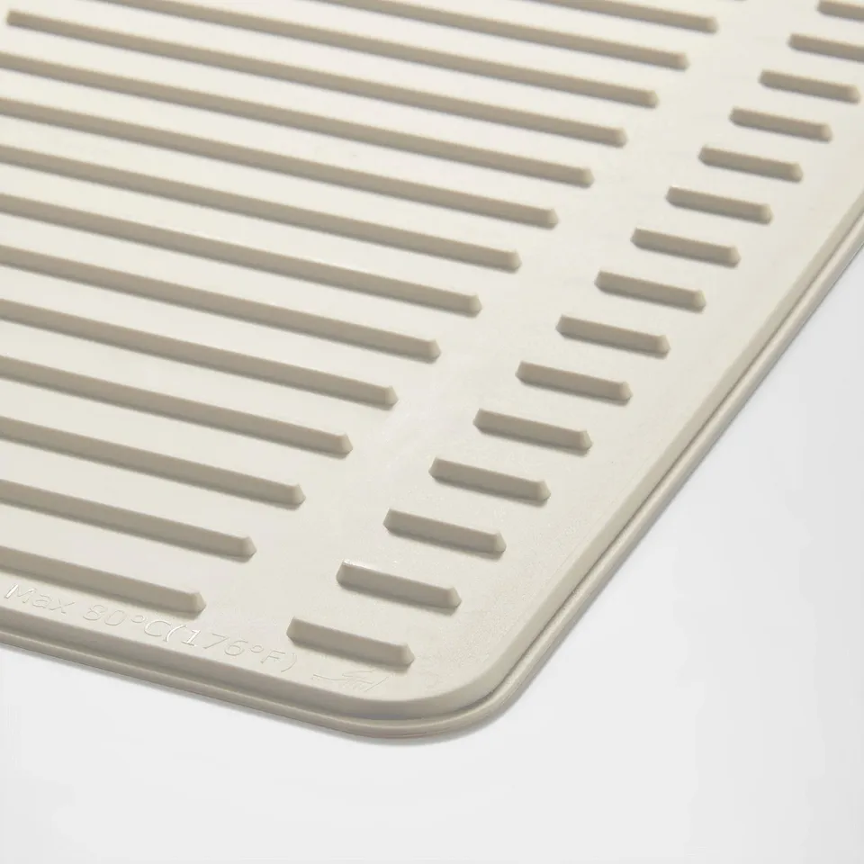 Close-up of a folded RINNIG drying mat showcasing its raised, ridged texture for optimal drainage and non-slip surfaces.