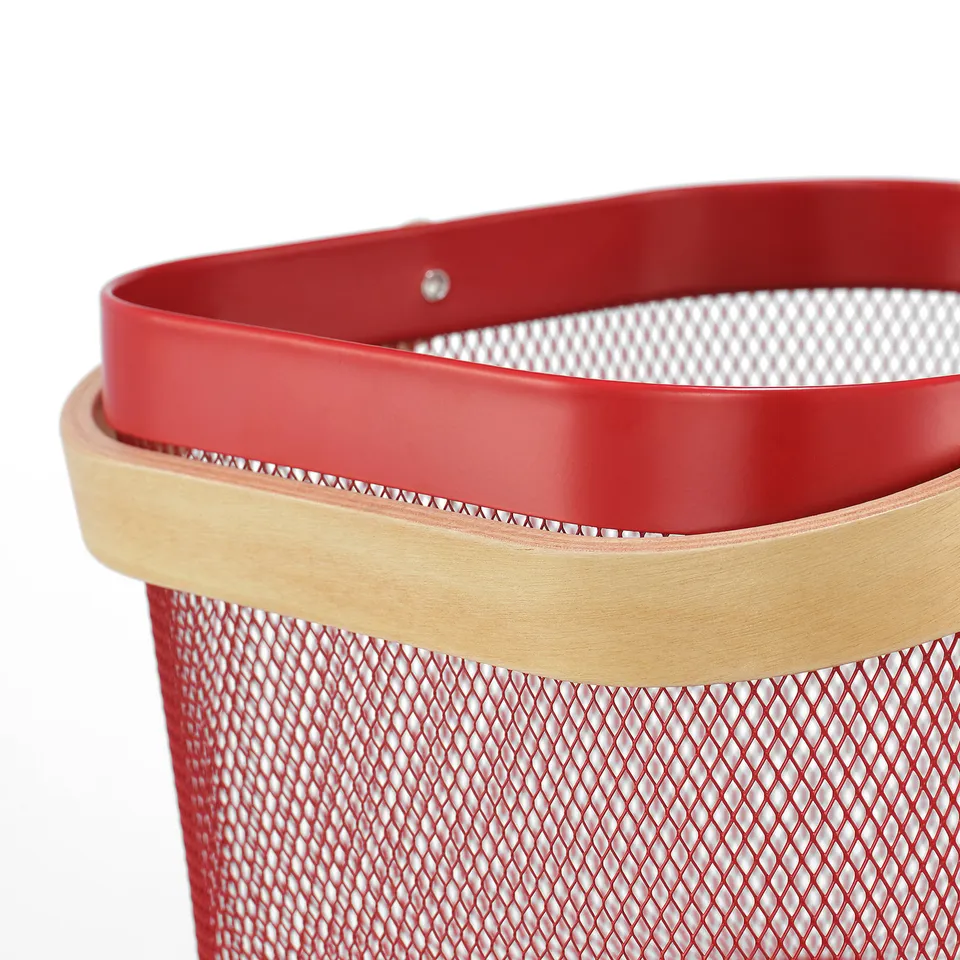Red metal mesh storage basket with wooden handle; designed for kitchen or home.