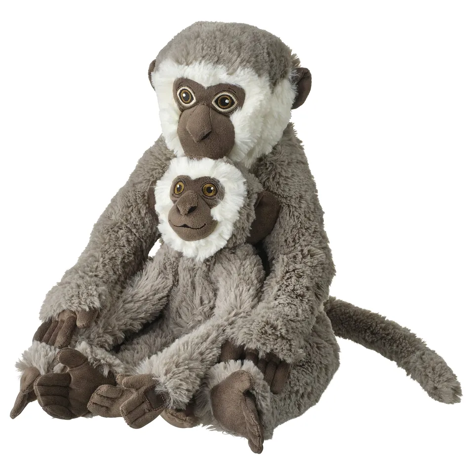Two plush grey and white monkeys, one holding a smaller monkey, soft material, realistic design.