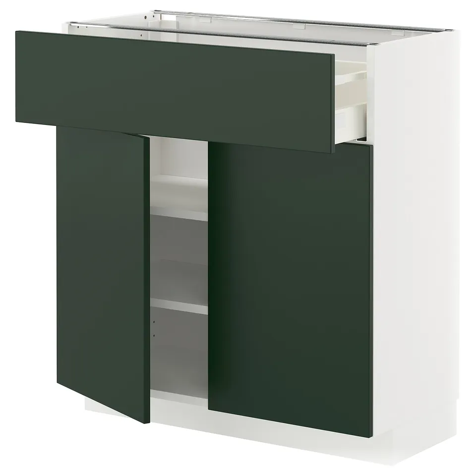 Modern white and green kitchen unit with open drawer and shelves, sleek design.