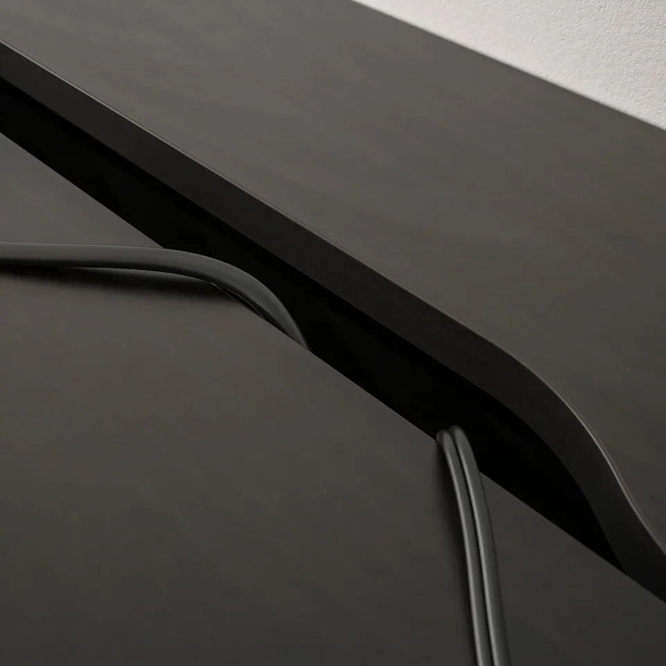 Modern desk with sleek, minimalist design; built-in cable management and storage drawers visible.