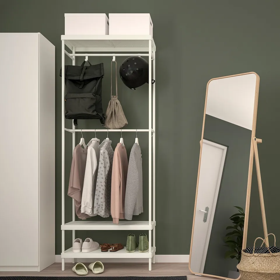 MACKAPÄR coat rack with storage & mirror against green wall.