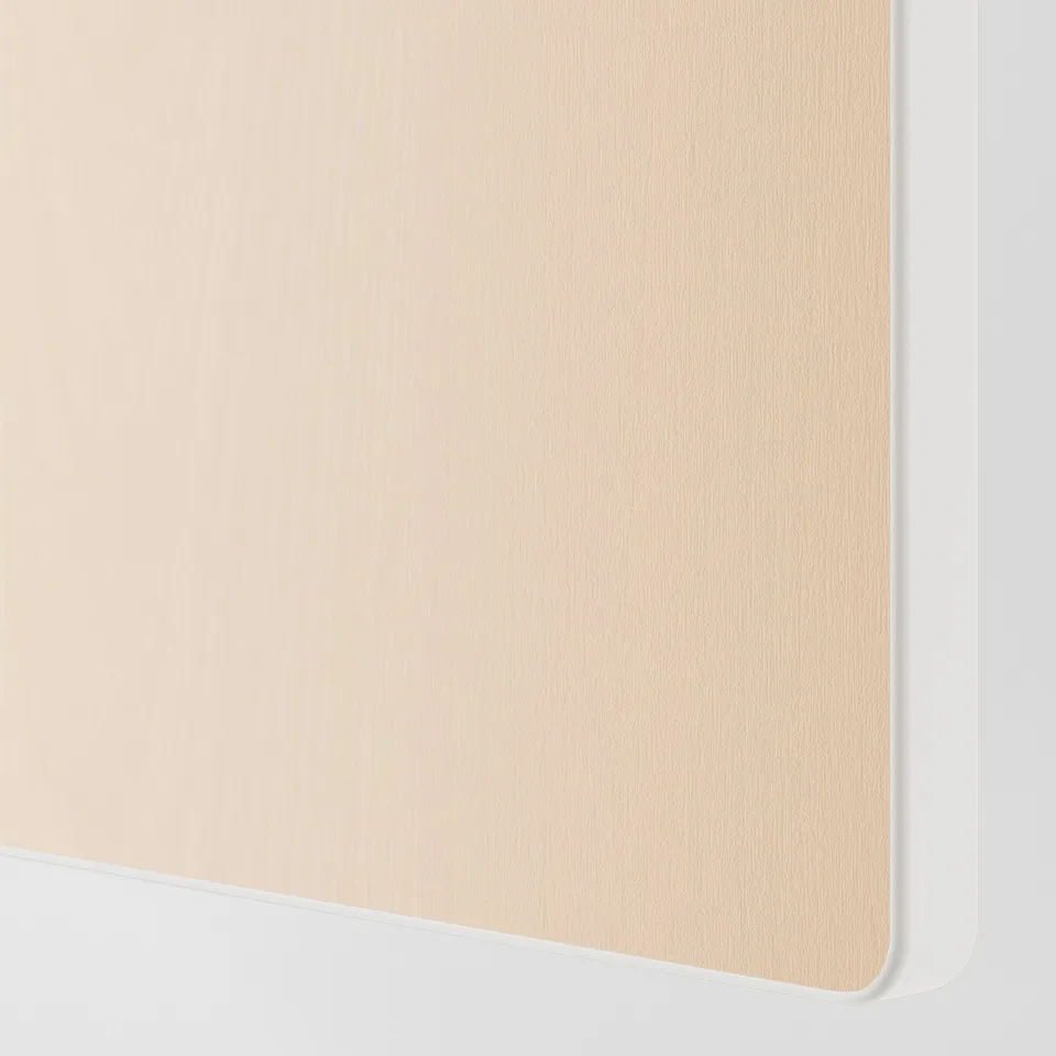 Close-up of smooth, light-colored wooden surface, showing fine grain texture and clean, precision-cut edges.