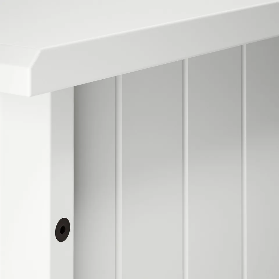Close-up of clean, white vertical panelling with sleek edges, showcasing quality craftsmanship.