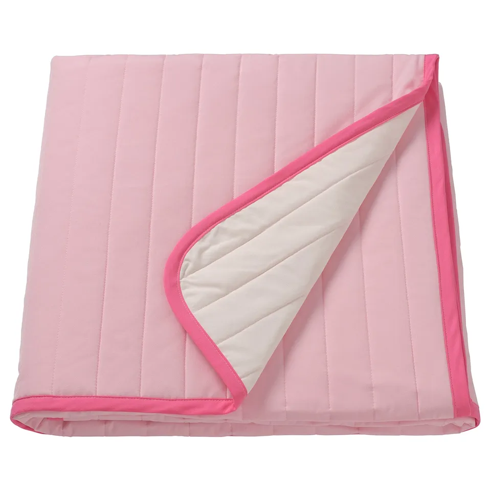 VETEJORDFLY pink & white quilted bedspread. Soft, rectangular with pink edging.
