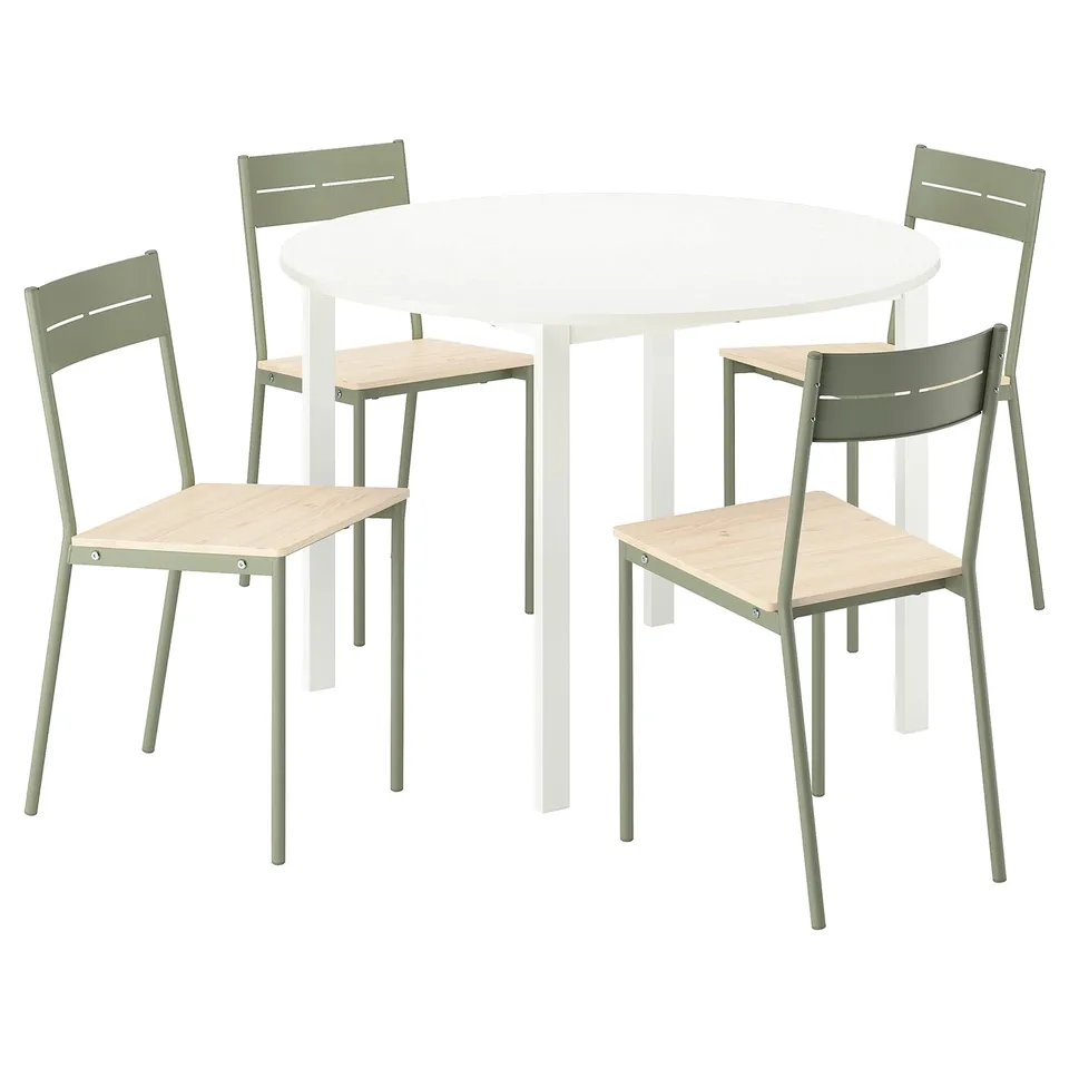Depicts a round white table with four matching green chairs featuring wooden seats. Modern and functional design with metal frames.