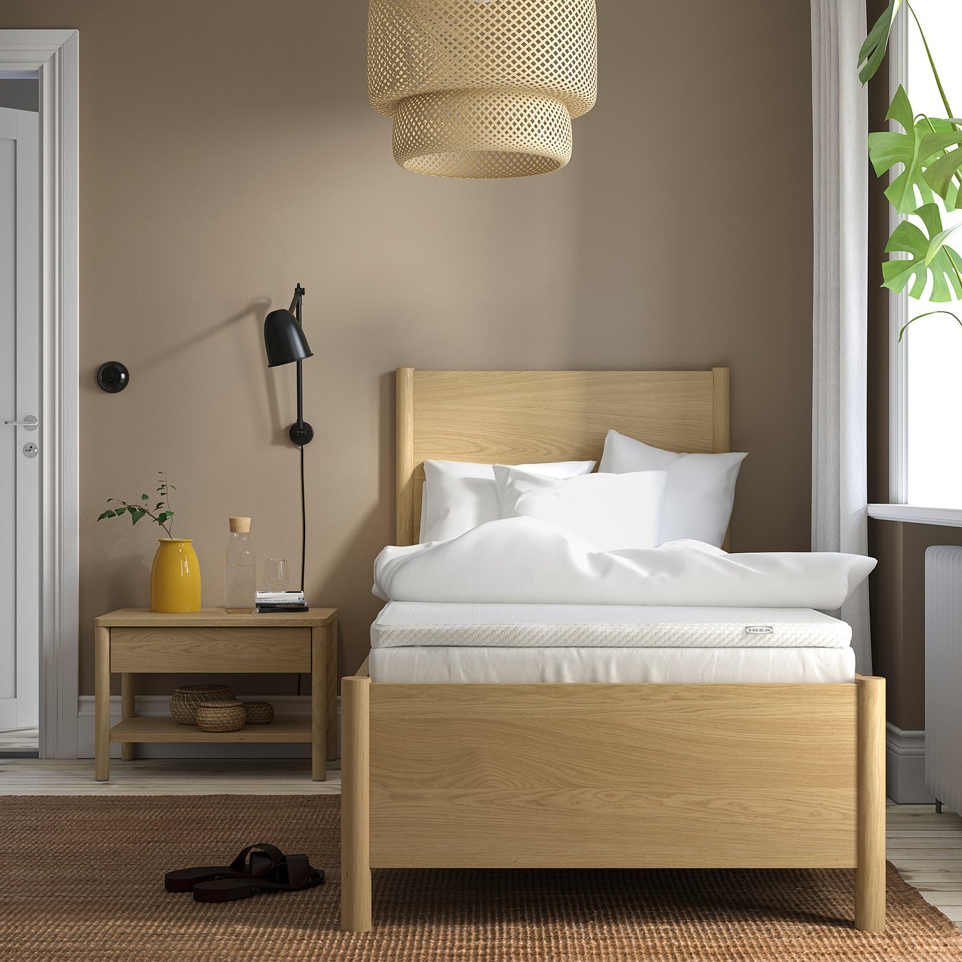 Cosy bedroom with VALEVÅG bed, pendant light, plant, and bedside table.