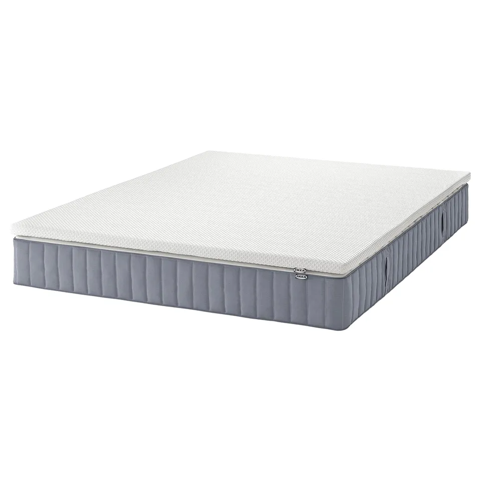 IKEA VALEVÅG white rolled mattress, rectangular, with grey sides, featuring pocket springs and foam for comfort and support.
