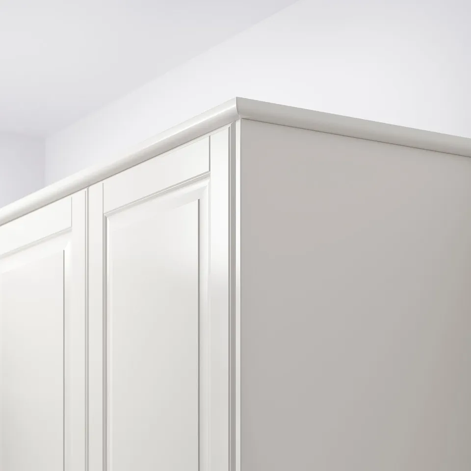 White cabinet trim hiding lights, rounded edges.