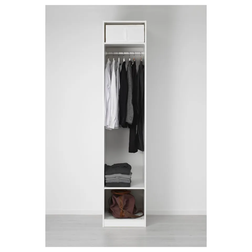 White PAX wardrobe with hangers, folded clothes, bag.