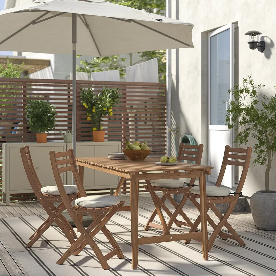 Wooden patio set with foldable chairs & table for cosy dining.