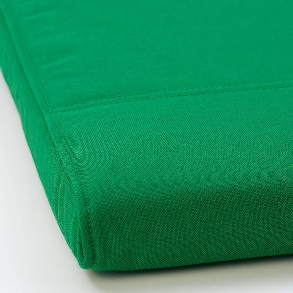 Green fabric with neat seams, smooth texture, and subtle two-tone effect. High-quality, durable look.