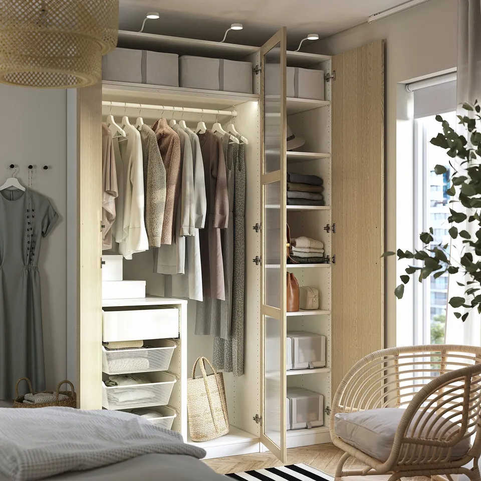 Closed wardrobe displaying inner organisation: clothes hangers, shelves, and storage boxes.