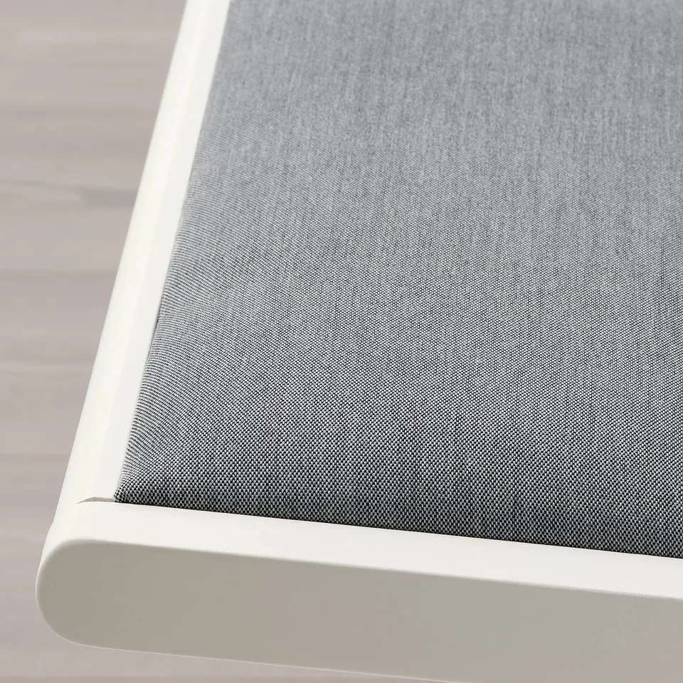 Modern fabric chair with sleek white frame, smooth and durable.