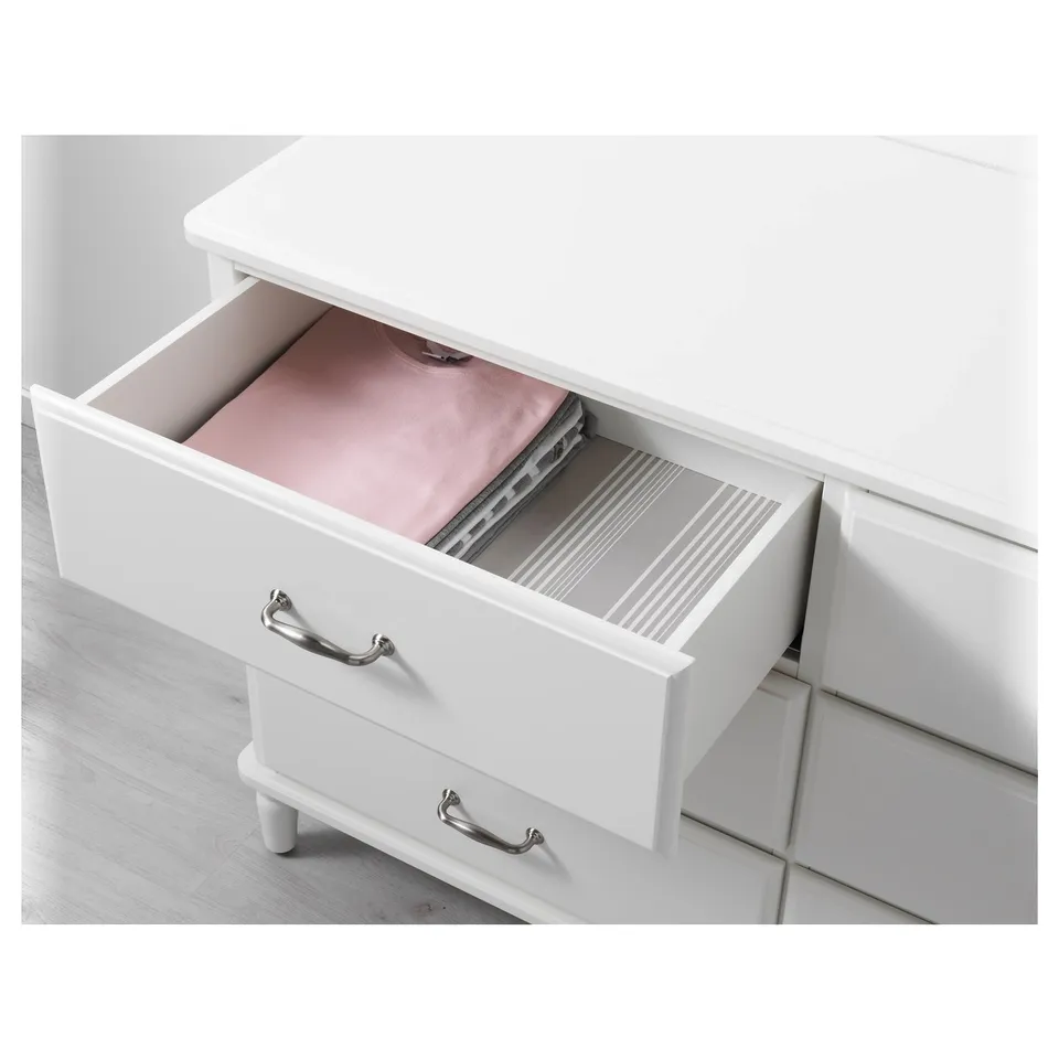 White chest with one drawer open, showing inner divider and soft closing mechanism.