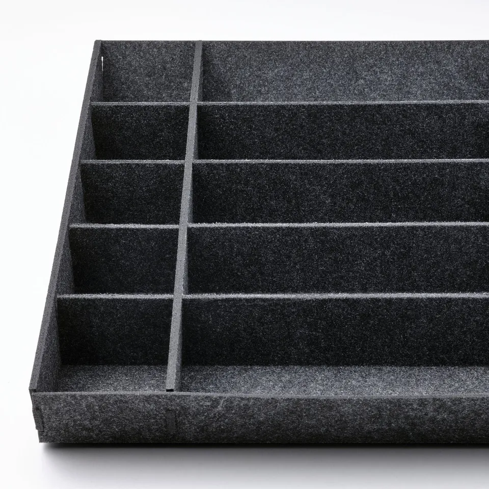Black drawer organiser with customizable compartments, made from soft polyester material.