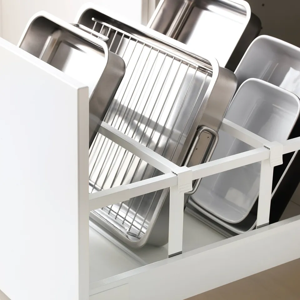 Kitchen drawer organiser holding several baking trays and pans, ensuring easy access and tidy storage.