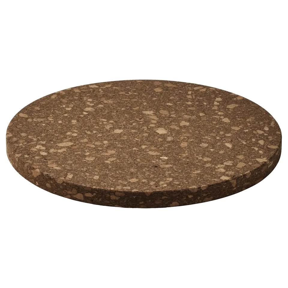 A brown circular cork HEAT-resistant trivet.