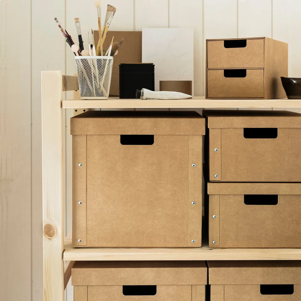 GÄRDESGÅRD tan boxes on wood shelves. Perfect for storage, sturdy, handles for easy pull. Aligns neatly with other units.
