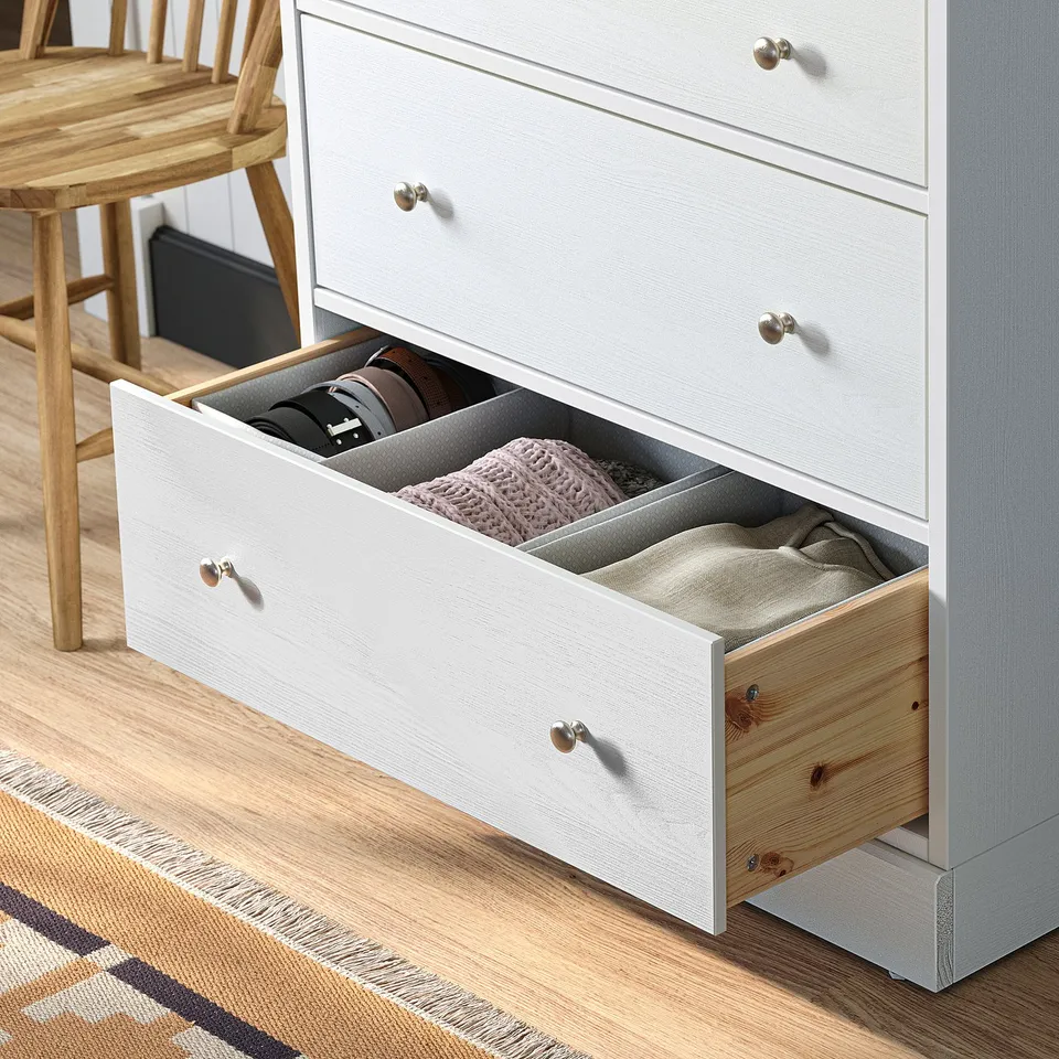 Open white HAVSTA chest with folded clothes and accessories visible, showing storage functionality.