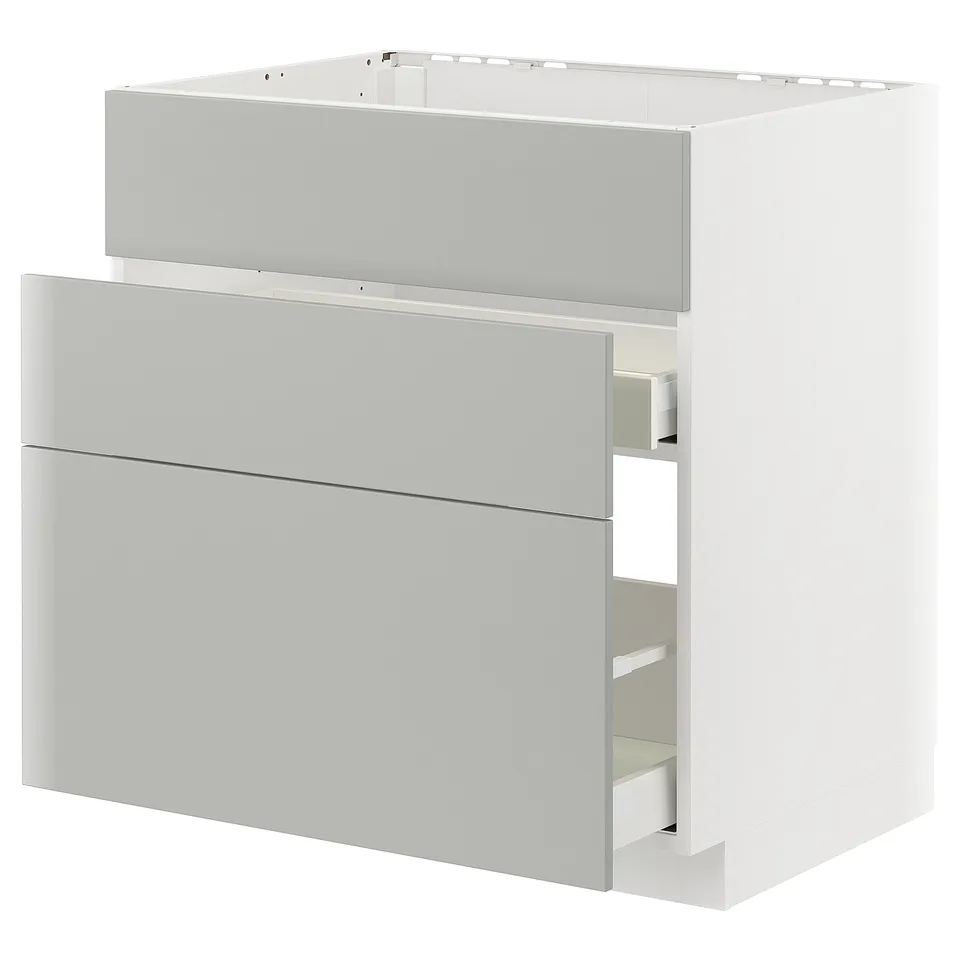 Modern light grey kitchen unit with sleek handles and drawers.