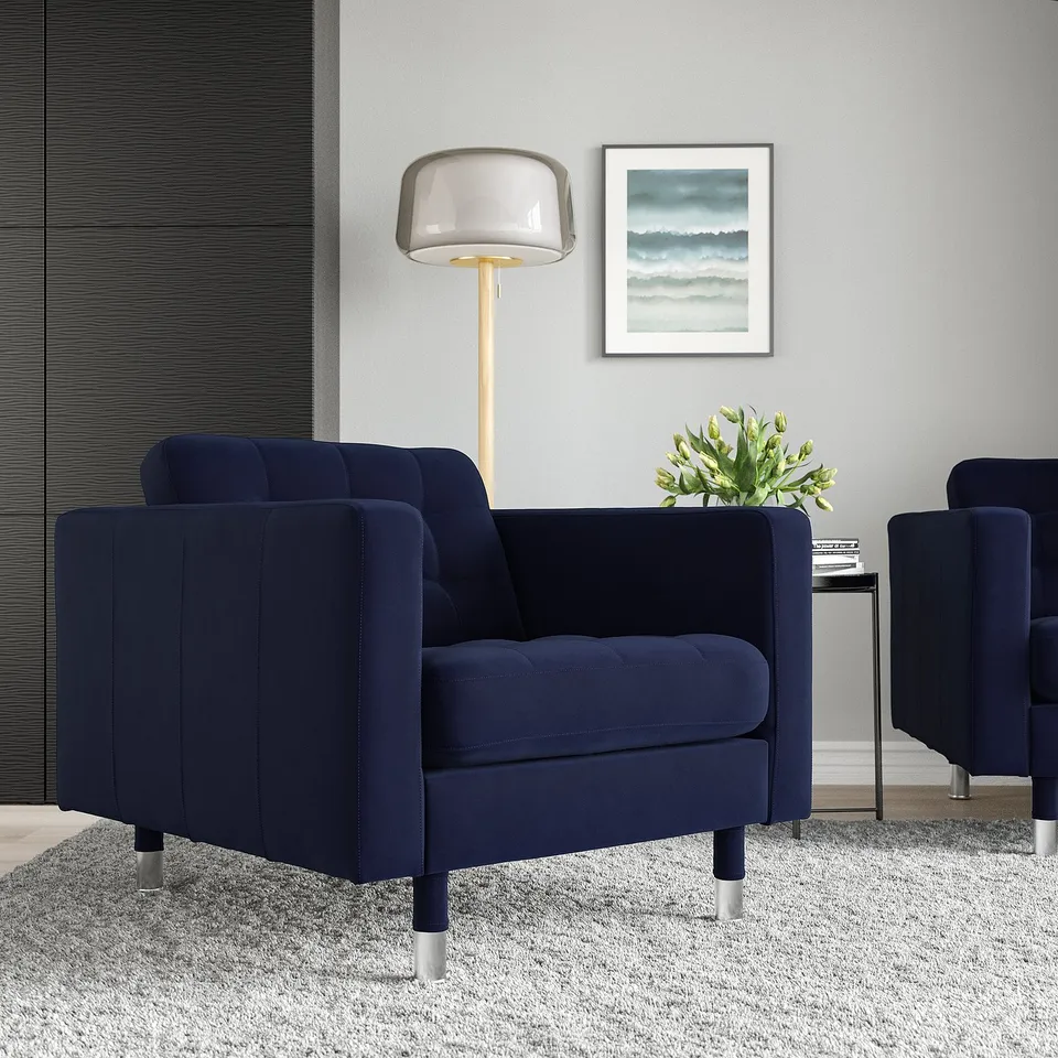 Navy LANDSKRONA armchair with cushions in modern room, next to lamp and abstract art, perfect for small spaces.