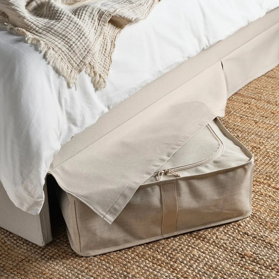 Upholstered bed frame with removable, machine-washable cover. Shows storage space under bed; soft headboard for comfort.