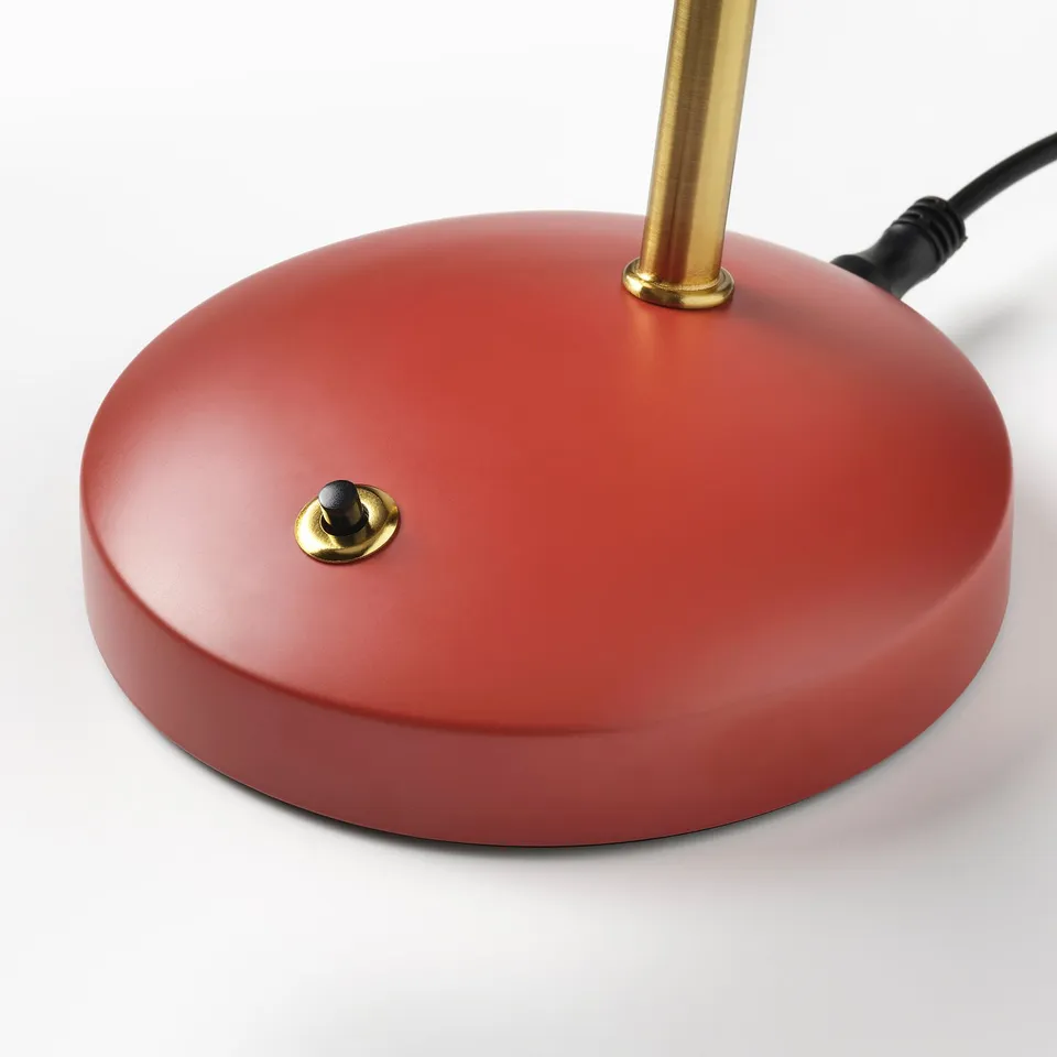 Red desk lamp base with smooth surface and gold accents. Flexible gooseneck design. On/off switch at base.