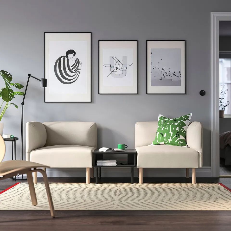 Modern living room with LILLEHEM sofa, art, green accents, and minimalistic decor.