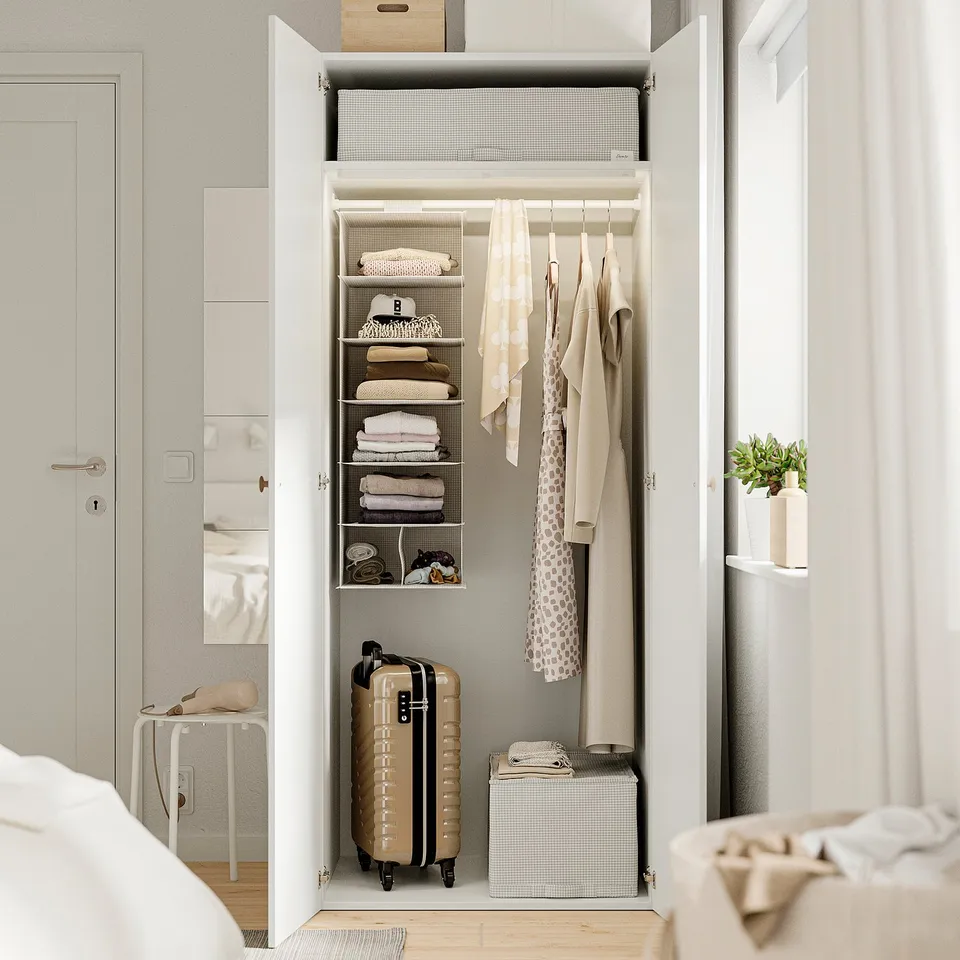 Open wardrobe with folded clothes, hanging coats, and storage boxes. Adjustable feet for floor irregularities.