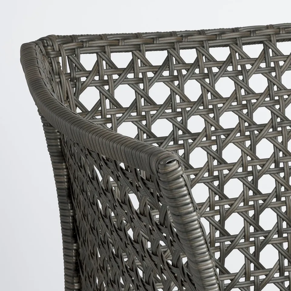 Close-up of durable, grey wicker chair, intricately woven, strong design.