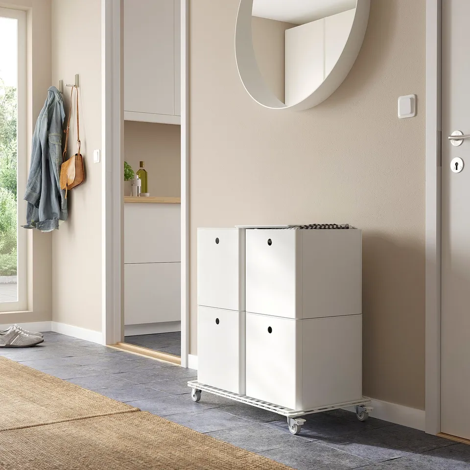 Small white KUGGIS storage box with lid for organising items, fits well in spaces near door or cabinet.