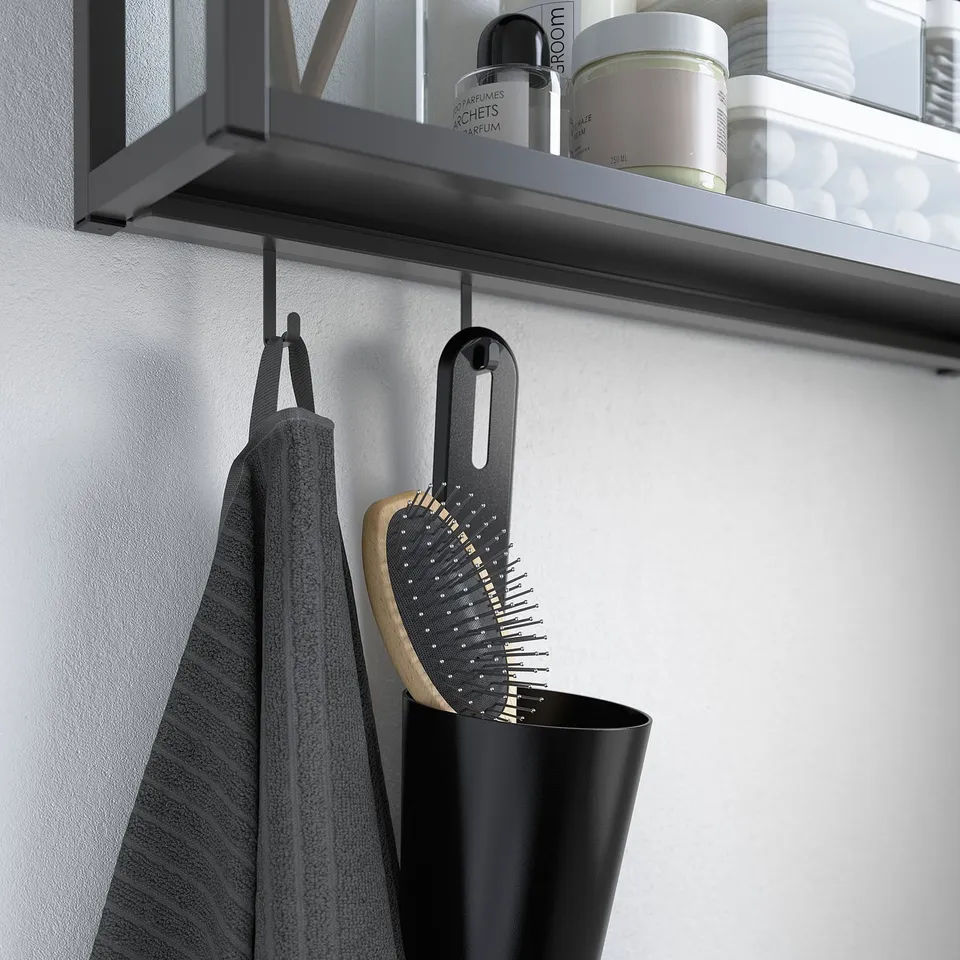 Bathroom wall hooks on shelf. Holds towel and hairbrush, saves space.