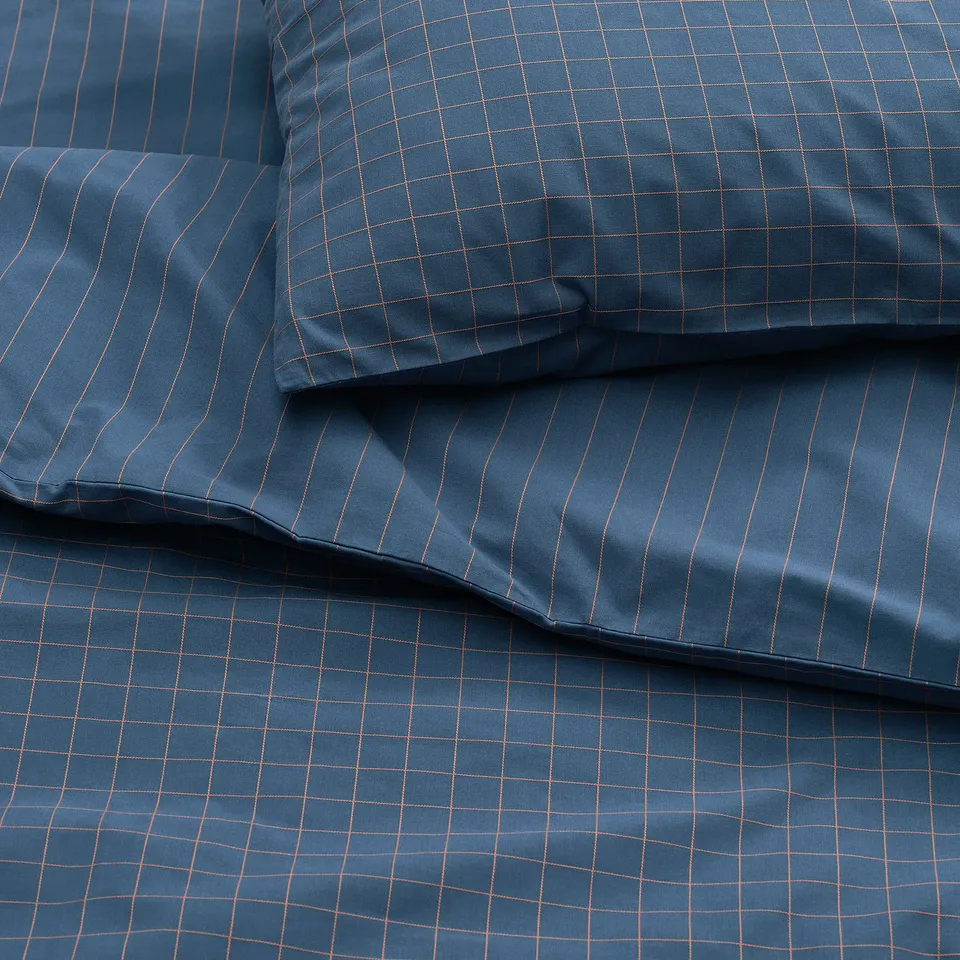 Dark blue DOFTAKLEJA duvet cover with stitched check and stripe patterns; soft, high-quality cotton.