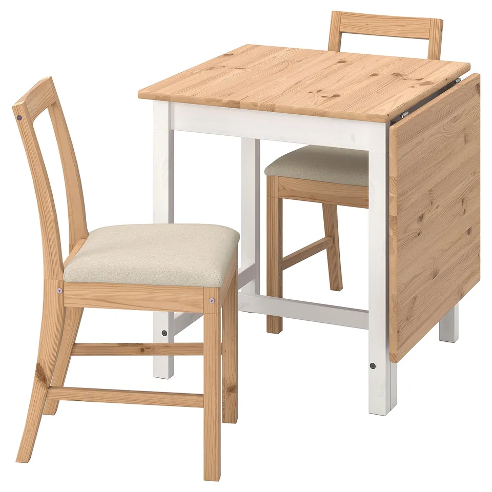Wooden drop-leaf table with two chairs. Natural wood top, white legs. Beige cushioned seats. Minimalist design.