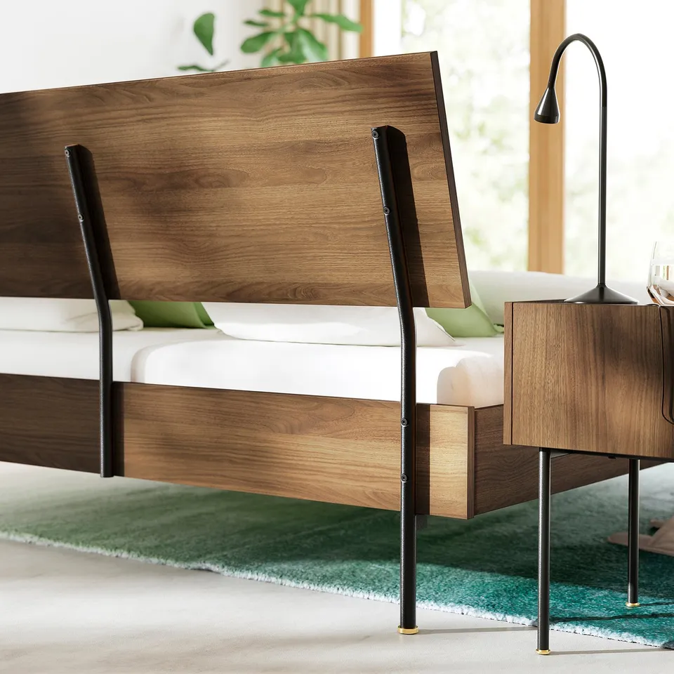 Mid-century style bed with walnut finish, featuring slatted base for air circulation and adjustable headboard.