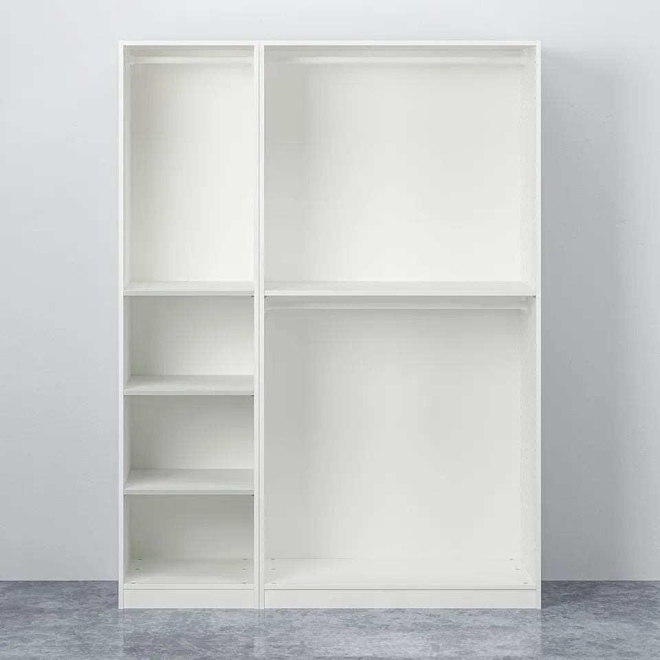 A white PAX wardrobe with adjustable shelves, no items inside, against a grey wall.