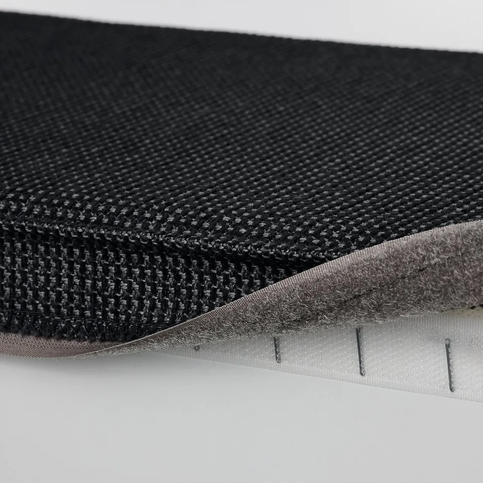 Close-up of KIVIK footstools velcro fastening, showing fabric texture and attachment detail.