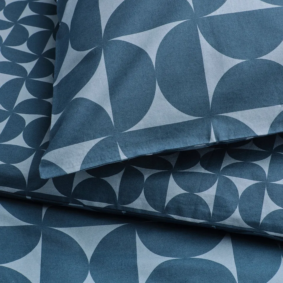 Folded duvet set featuring geometric dark & light blue patterns, crisp & smooth texture.