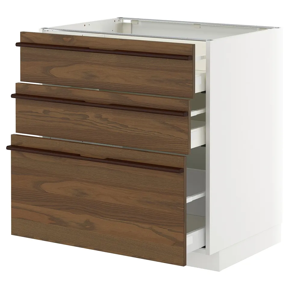 Modern kitchen cabinet, METOD by IKEA. Dark brown wood, white frame, three drawers with wooden handles.