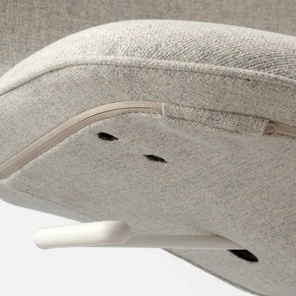 Close-up of a modern, fabric-covered office chairs seat edge, showing neat stitching and quality material.