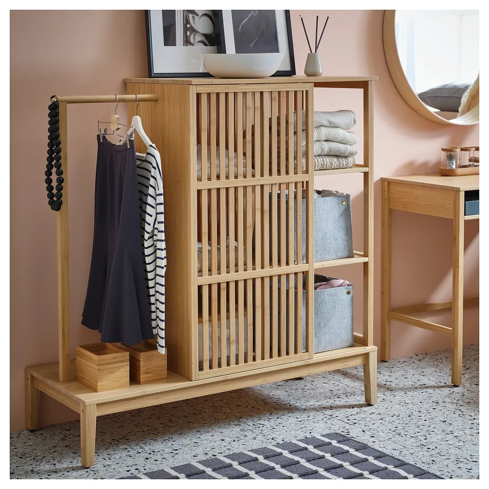 Scandinavian-style bamboo wardrobe with clothes and shelves, natural wood colour.