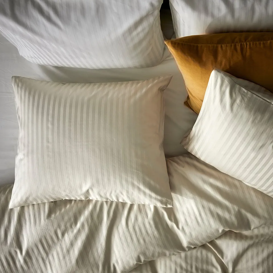 NATTJASMIN bedding: white, striped, rectangular pillows and duvet on soft fabric.