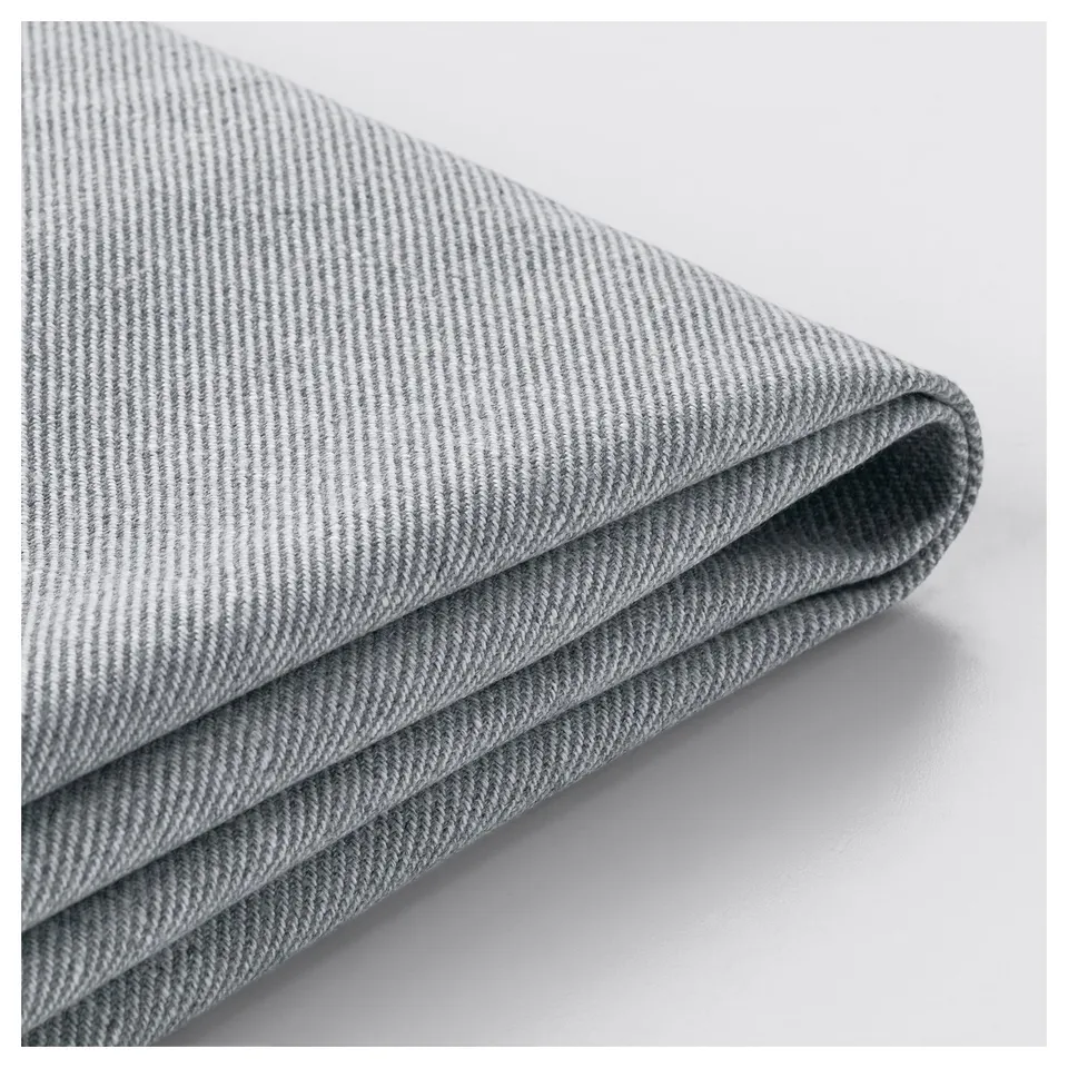 A close-up shot of a sleek, grey, textured fabric fold, showcasing its smooth texture and high-quality material, likely from a TULLSTA armchair cover.