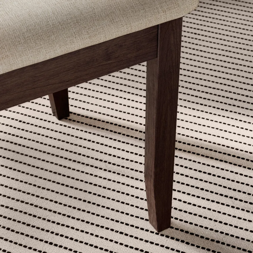 A close-up of a wooden table leg, showcasing its sturdy and polished design.