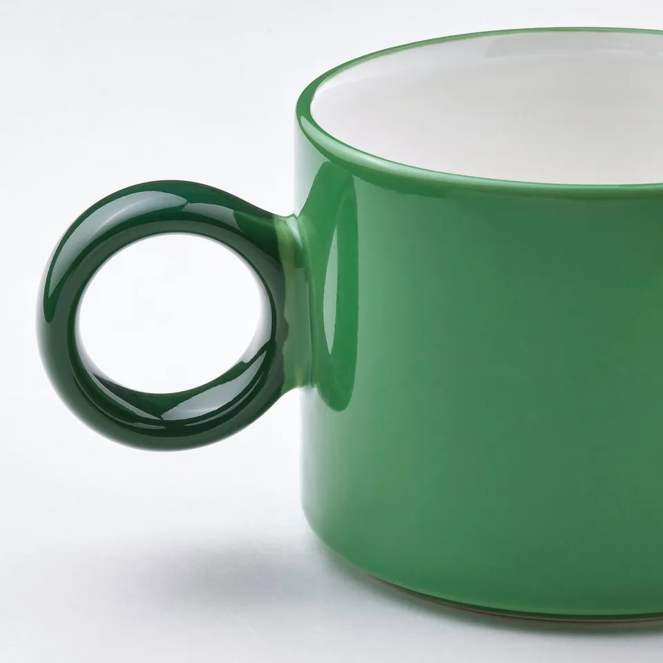 Glossy green mug, smooth handle.